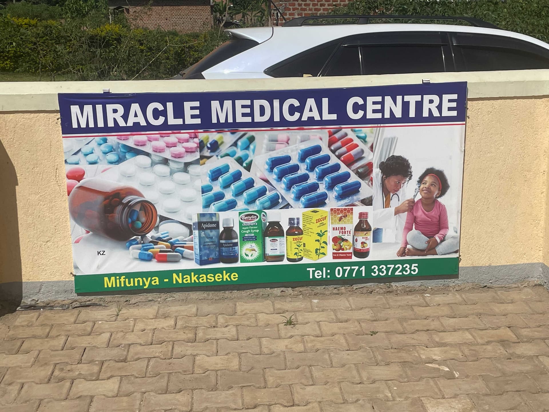 Roadside signboard for Miracle Medical Centre listing services offered, Mifunya-Nakaseke.