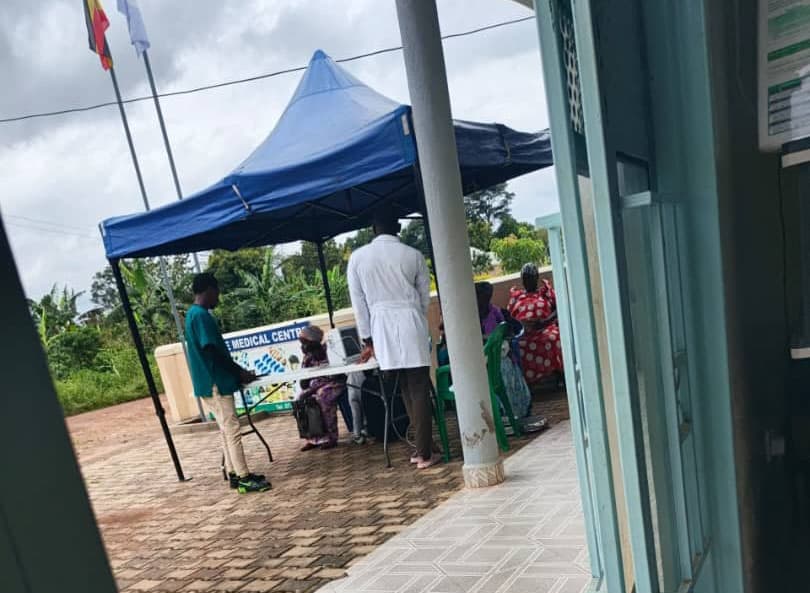 A blue tent is set up outside the Miracle Medical Centre building for the hypertensive clinic outreach.