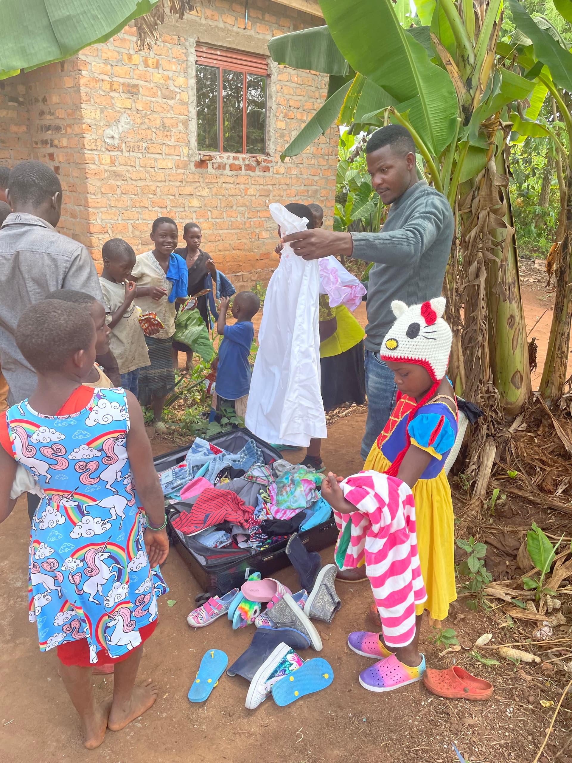 An overhead view of a pile of colorful donated children's clothing being sorted for distribution.