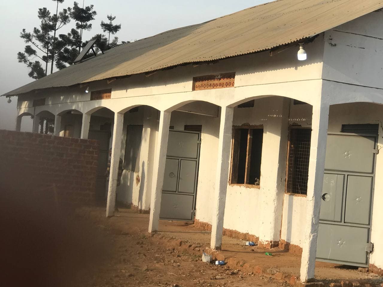 Exterior of a church or school building with a covered porch and arched columns.