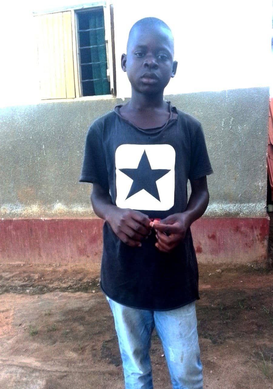Bruhan stands outdoors wearing a black t-shirt with a white star print.