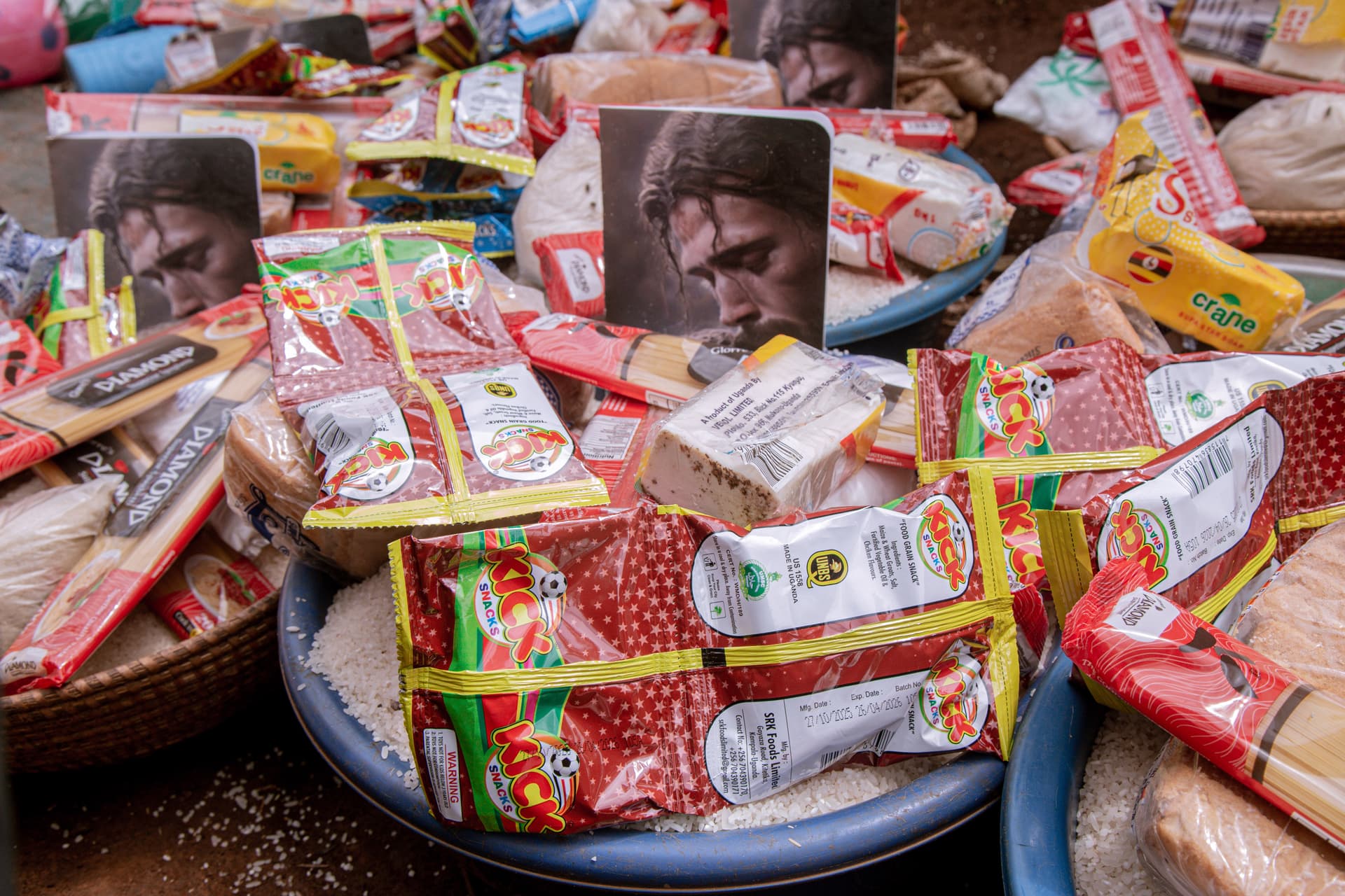 A basin filled with wrapped Christmas food packages ready for a family to receive.