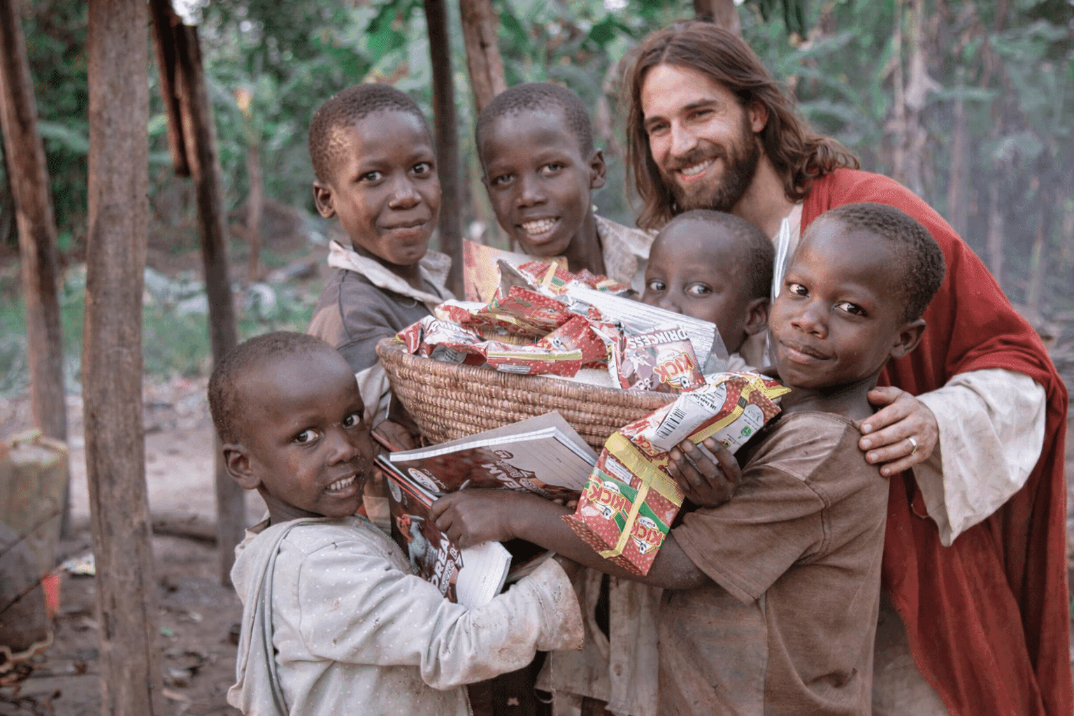 Illustrated depiction of Jesus surrounded by children, one holding a basket of food, in a forest setting.
