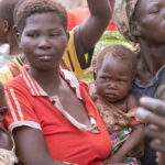 single mother carrying a child