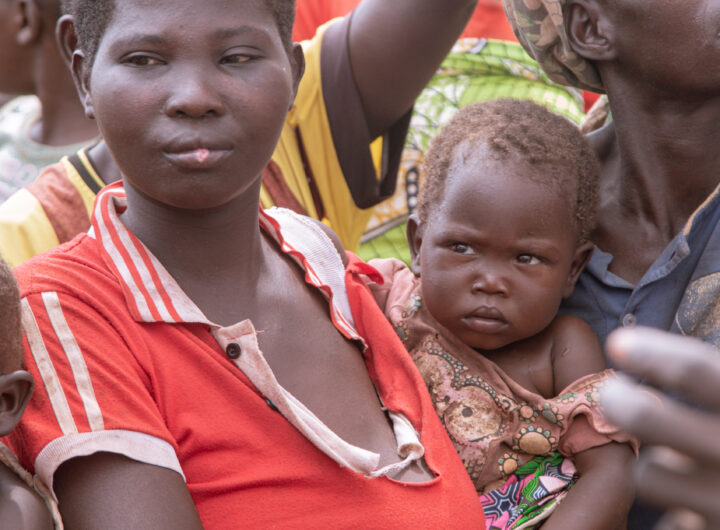 single mother carrying a child